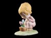 MENINA A OBSERVAR VASO COM FLORES